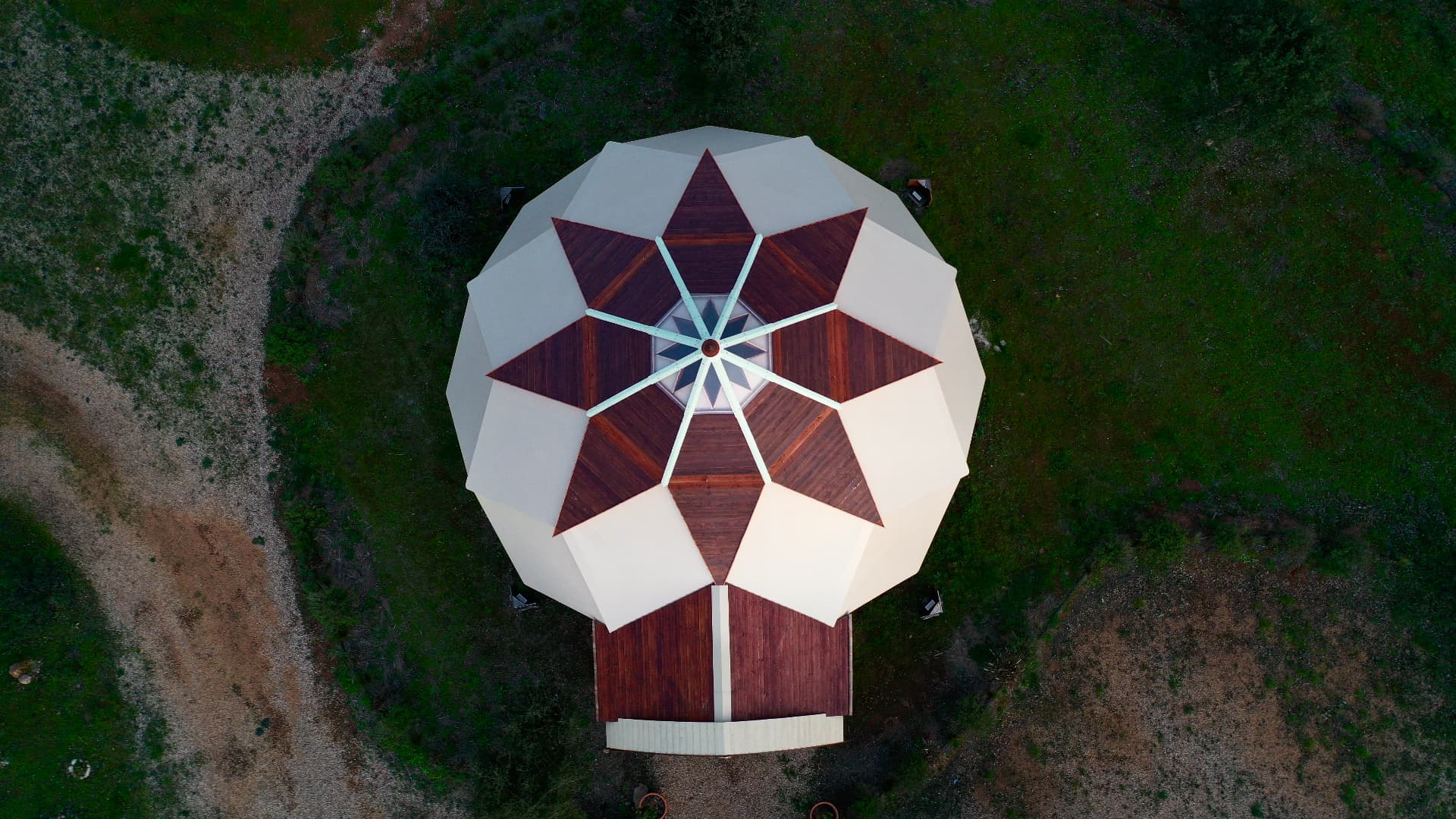 Aerial view of the star-shaped geometric roof of a Zome